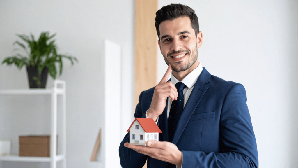 Real estate professional in a suit holding a miniature house to illustrate how home sellers can use flat fee MLS listings.