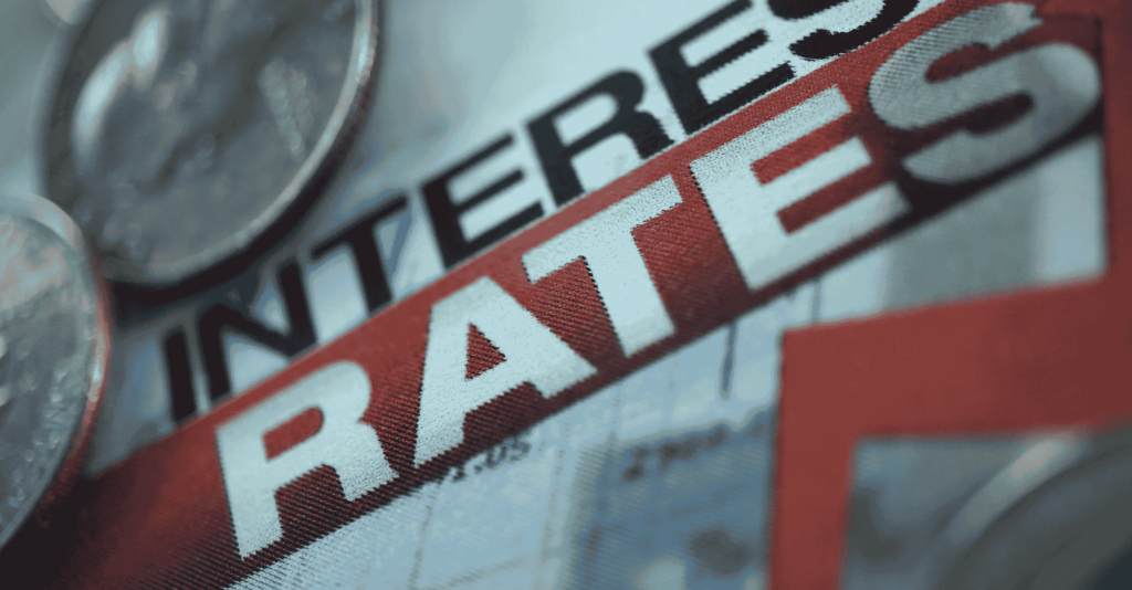 Close-up of the words ‘Interest Rates’ with coins in the background, symbolizing Federal Reserve policy and economic impact.