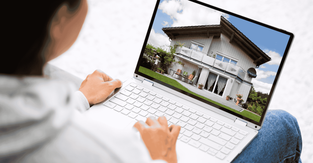 Person browsing a real estate listing on a laptop, showing a house with a garden and patio.