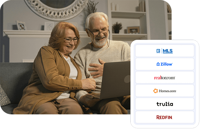 An older couple looking at a laptop screen smiling.