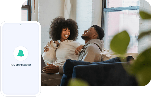 A couple with a pet dog are laughing.