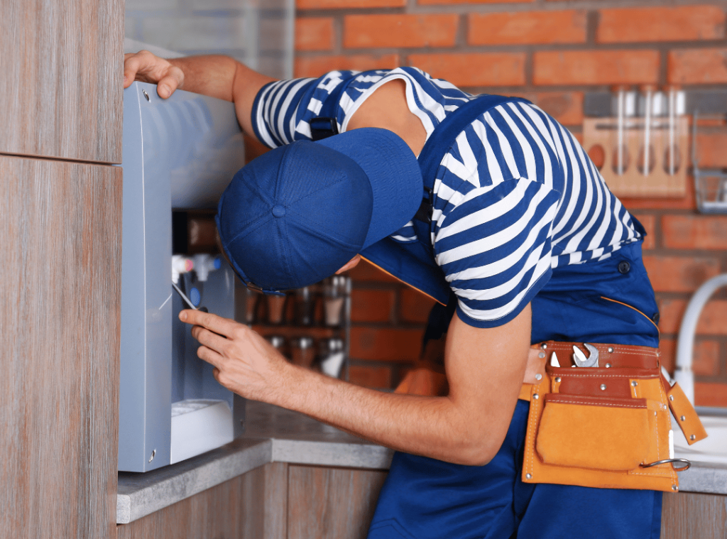 man looking at kitchen appliances and safety during home inspection