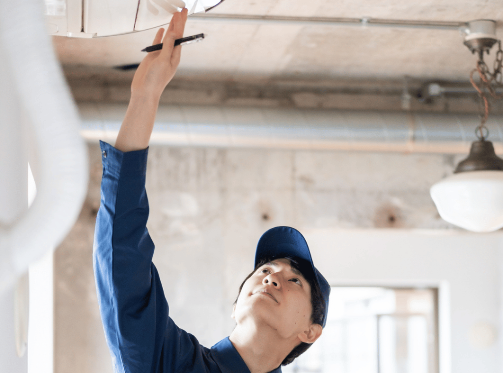 man checking roof and wall conditions during home inspection