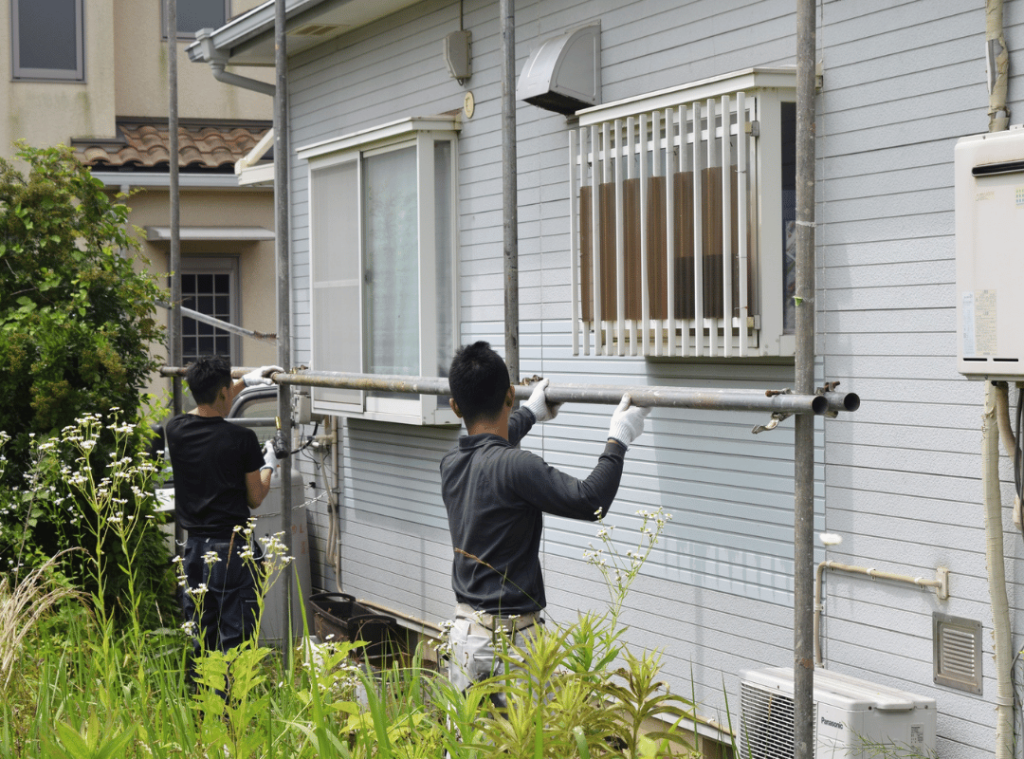 man checking the outside of the house during home inspection